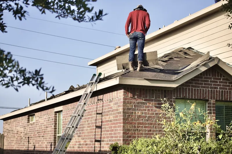 Professional roofer working on a residential roof in Emeigh